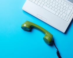 green handset and laptop on the blue background